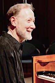 Andrew smiling and looking into the distance